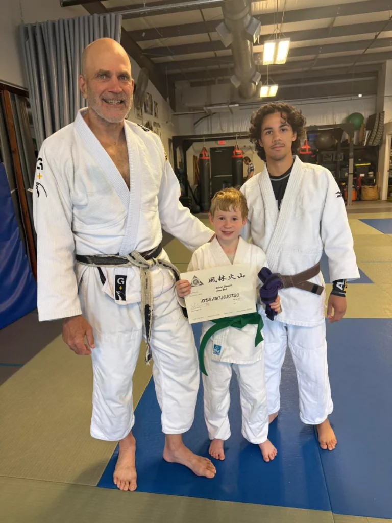 Happy kids in Acworth learning martial arts, improving balance, coordination, and having fun while building life skills.