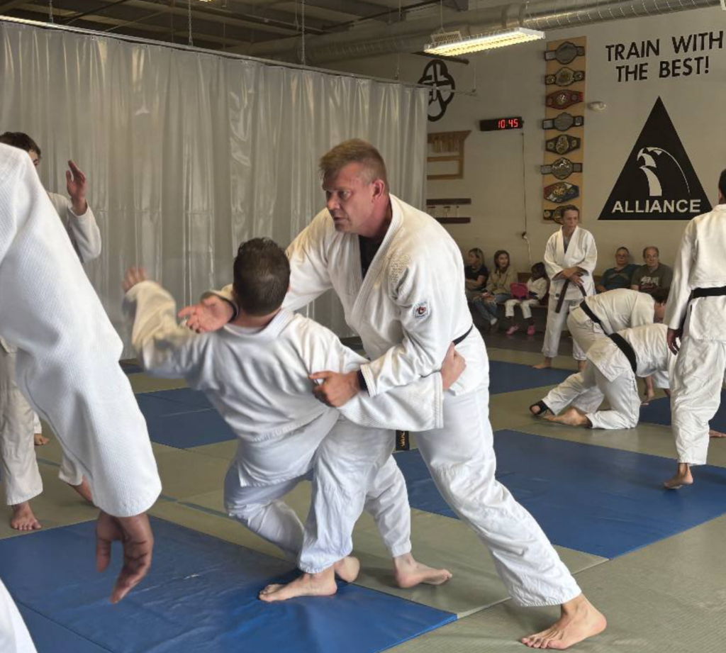 Adult martial arts instructor coaching student with focus mitts during fitness training in Acworth gym