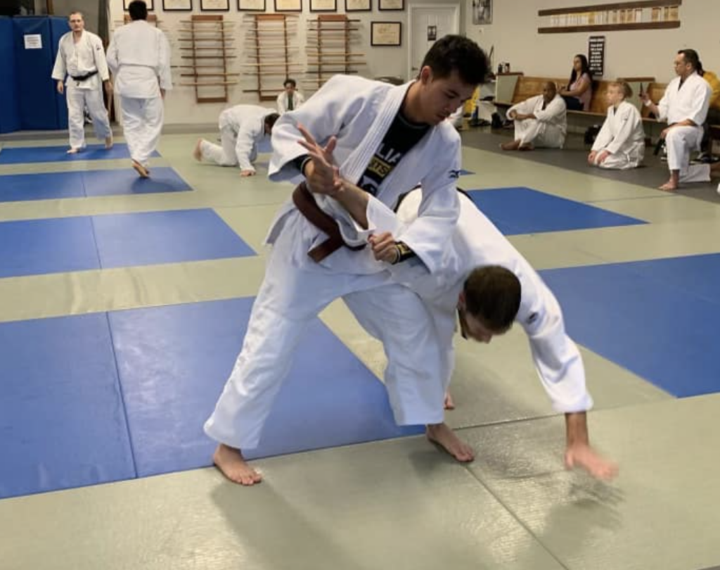 Adult martial arts students relaxing and socializing after training in Acworth gym